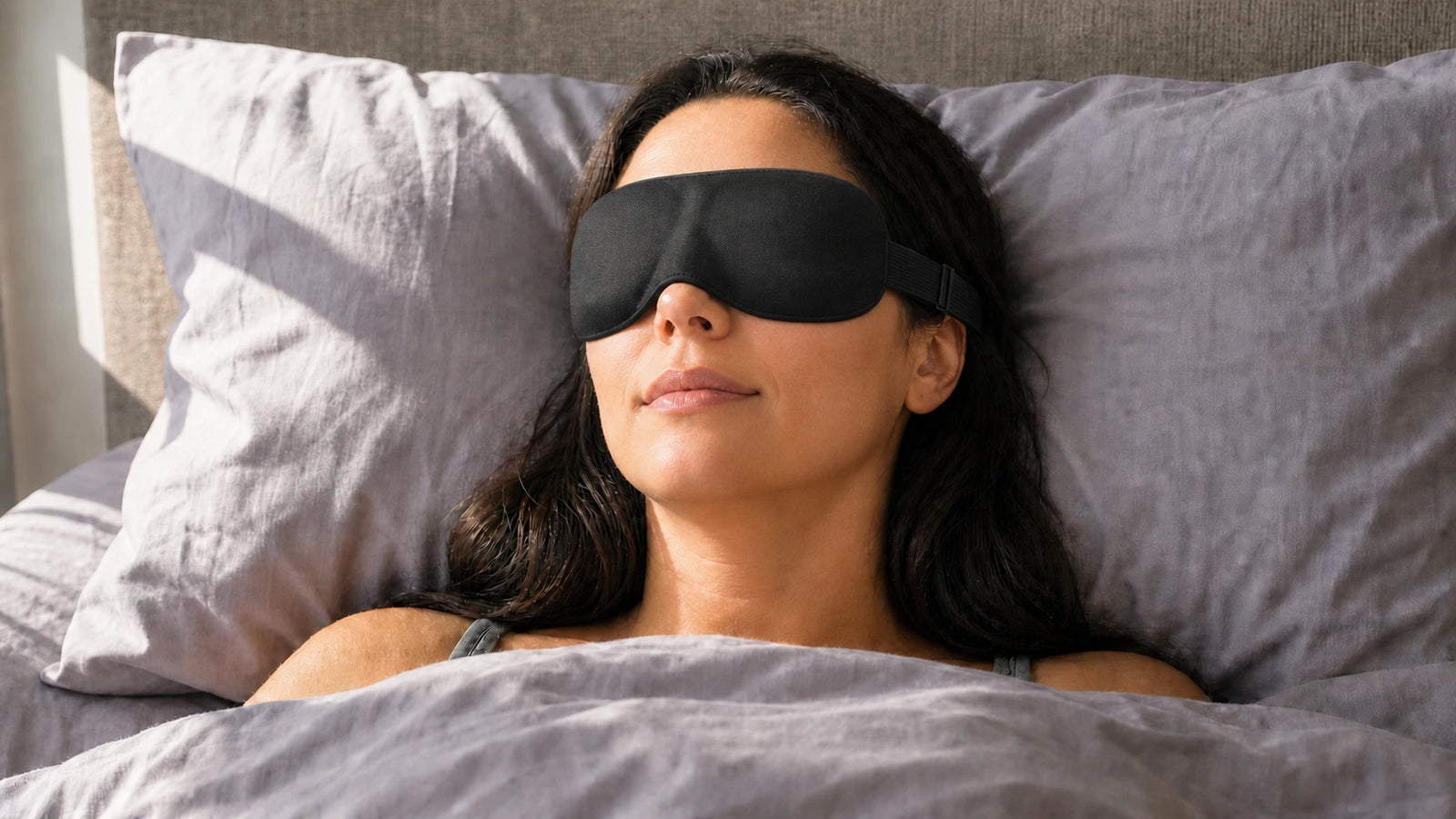 Same sleeper resting peacefully in bright morning light with the Lumiero NightSeal sleep mask